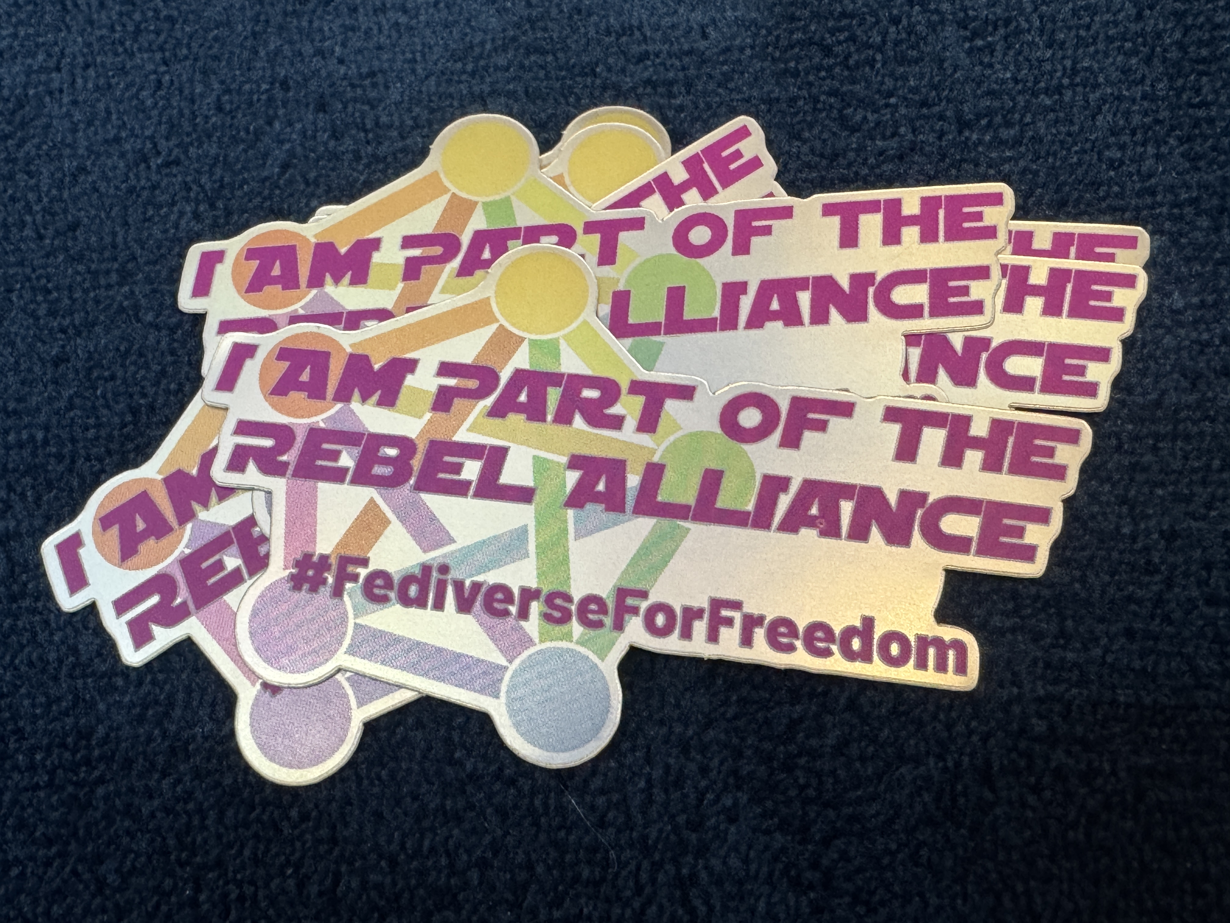 Fediverse for Freedom stickers on a table